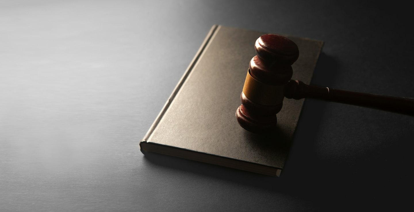 Mazo de madera sobre un libro de derecho cerrado.